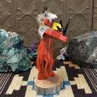 Navajo-made redtail hawk kachina doll by M. C. in red with raised leg, yellow beak, and fur collar.