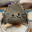 Sterling silver turquoise ring by Raymond Coriz featuring an oval turquoise cabochon, twisted rope bezel, concho-inspired fan design, and intricate Southwestern silverwork; artisan and Sterling Silver stamp.
