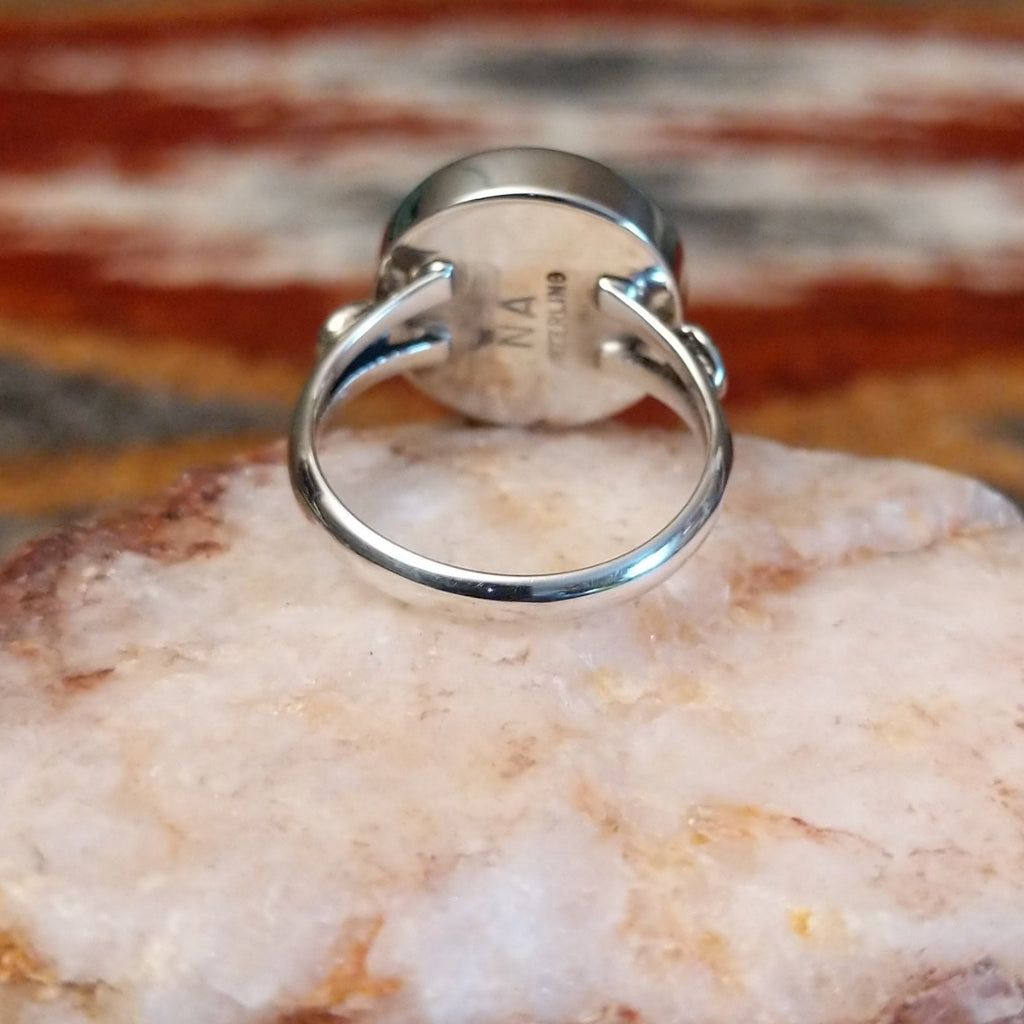 Sterling silver ring with round rhodochrosite set within the bezel and thin band.