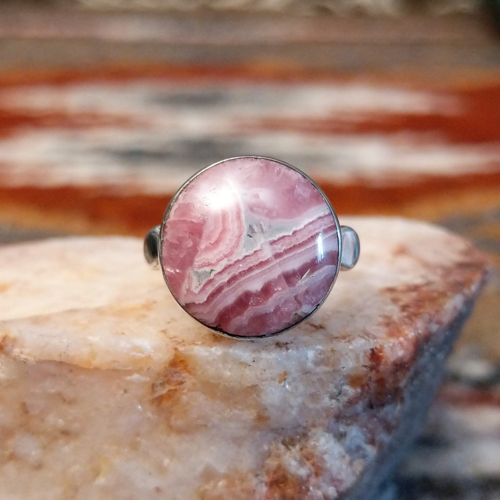 Sterling silver ring with round rhodochrosite set within the bezel and thin band.