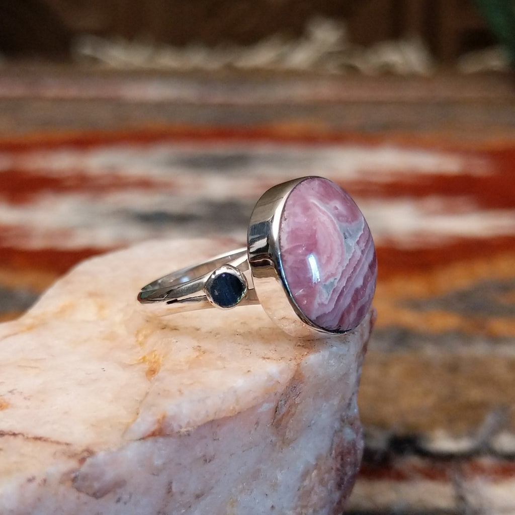 Sterling silver ring with round rhodochrosite set within the bezel and thin band.