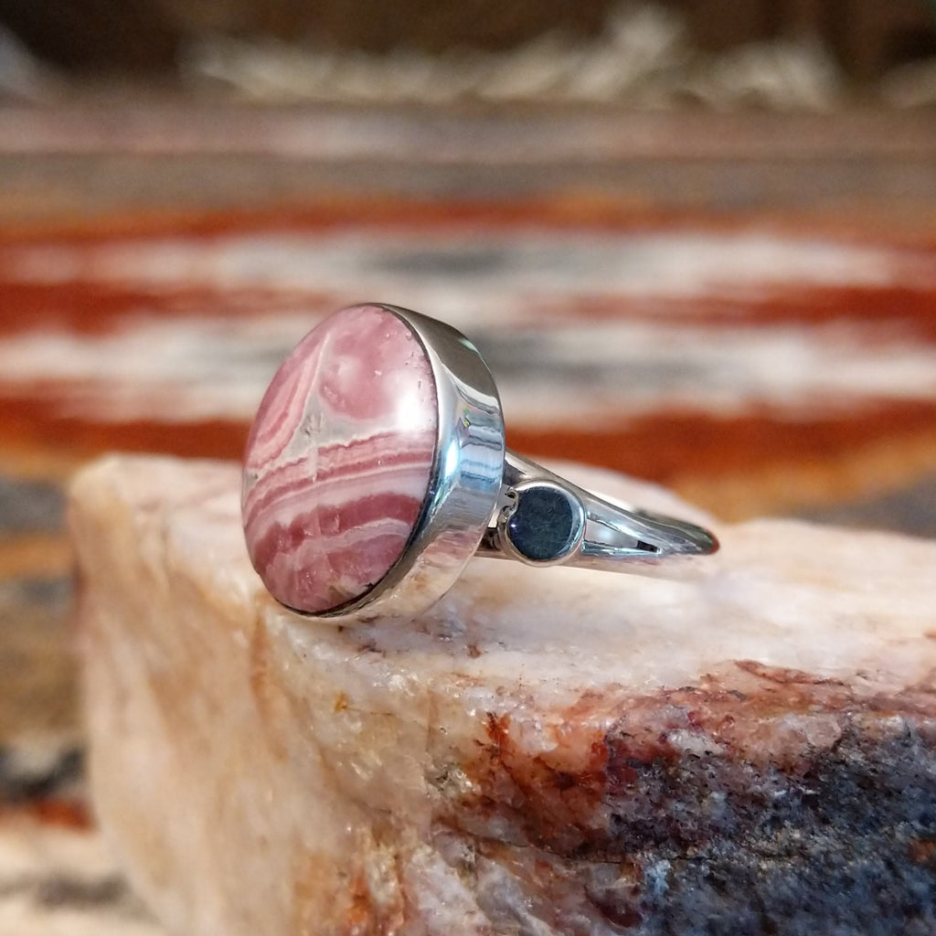 Sterling silver ring with round rhodochrosite set within the bezel and thin band.