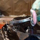 Oval rhodochrosite stone as the centerpiece on the sterling silver bracelet band.