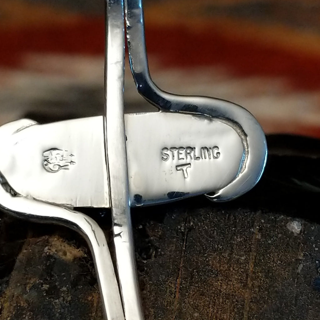 Close-up of the artisan's stamped signature.