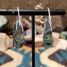Handcrafted sterling silver teardrop earrings by John King featuring natural rhodochrosite with soft pink and white banding in hand-stamped sterling silver settings on French hooks; artisan and Sterling Silver stamp.