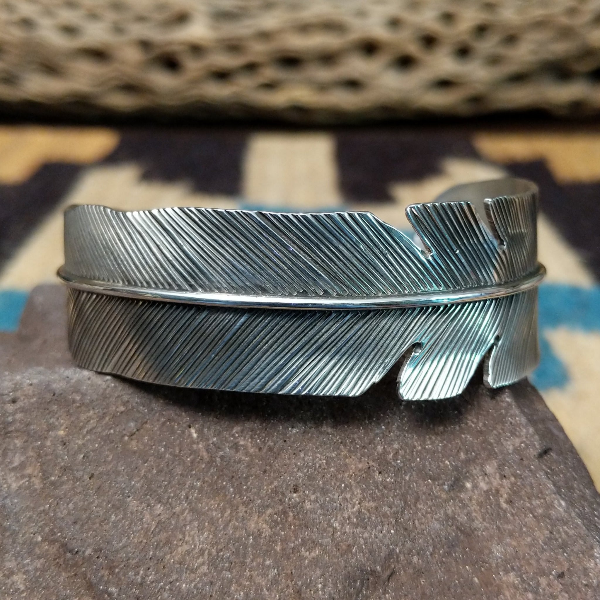 Rippling silver feather cuff by Terry Wood, featuring a handcrafted sterling silver feather design with flowing engraved details and traditional Southwestern-inspired craftsmanship.