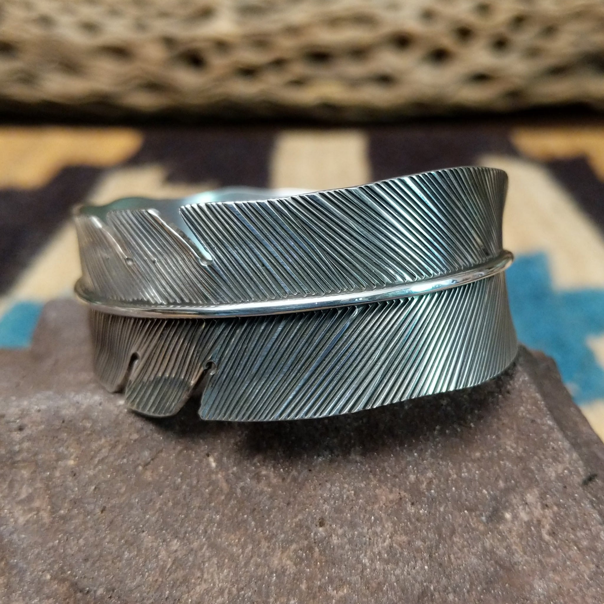 Rippling silver feather cuff by Terry Wood, featuring a handcrafted sterling silver feather design with flowing engraved details and traditional Southwestern-inspired craftsmanship.