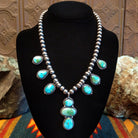 Necklace with Sonoran Gold turquoise spaced along the beaded silver chain, the bezels are framed by twisted rope and dotted accents.