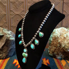 Necklace with Sonoran Gold turquoise spaced along the beaded silver chain, the bezels are framed by twisted rope and dotted accents.