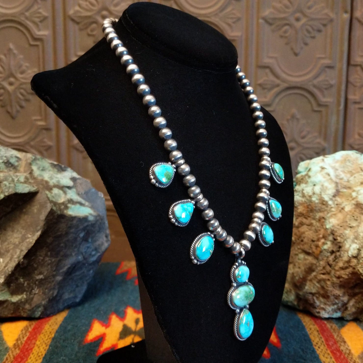 Necklace with Sonoran Gold turquoise spaced along the beaded silver chain, the bezels are framed by twisted rope and dotted accents.