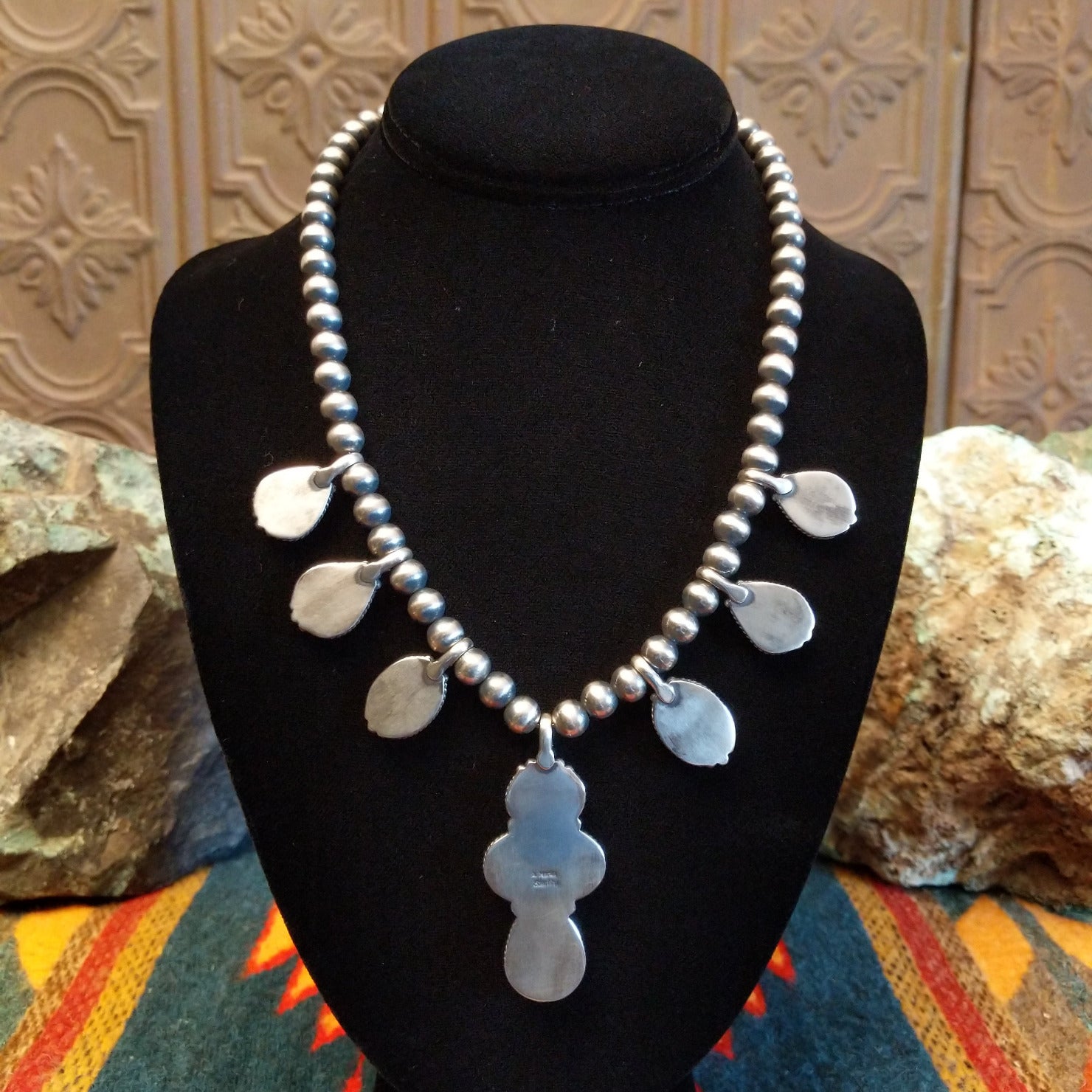 Necklace with Sonoran Gold turquoise spaced along the beaded silver chain, the bezels are framed by twisted rope and dotted accents.