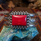 Rosarita set in the square bezel, framed by intricate dotted accents and a layered sterling silver band that forms the cuff.