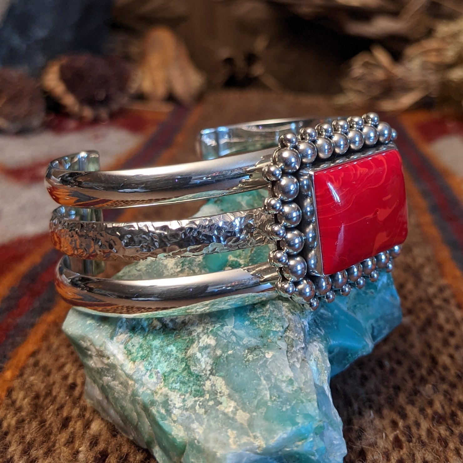 Rosarita set in the square bezel, framed by intricate dotted accents and a layered sterling silver band that forms the cuff.
