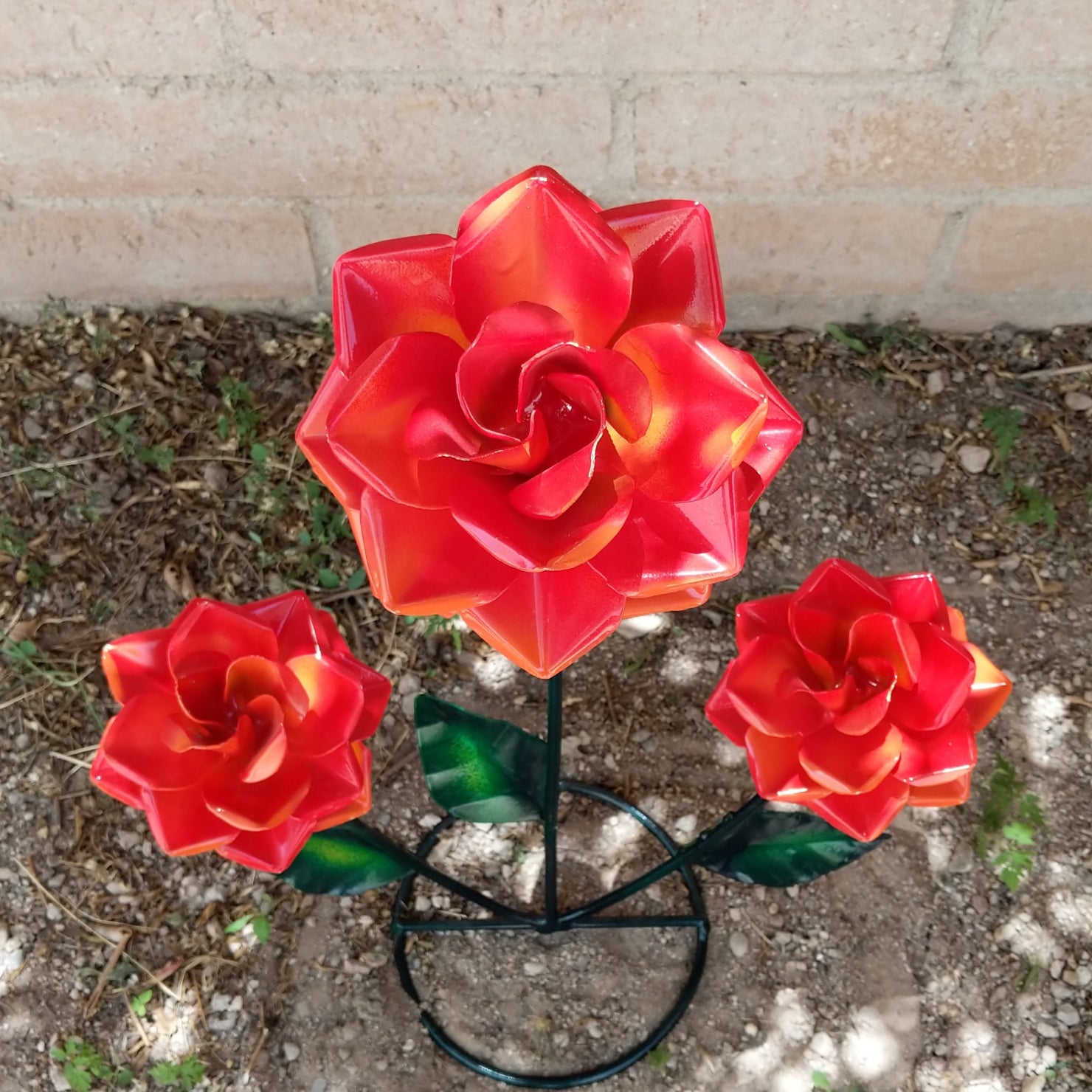 Close-up of the orange roses reveals intricate petal folds and green leaves.