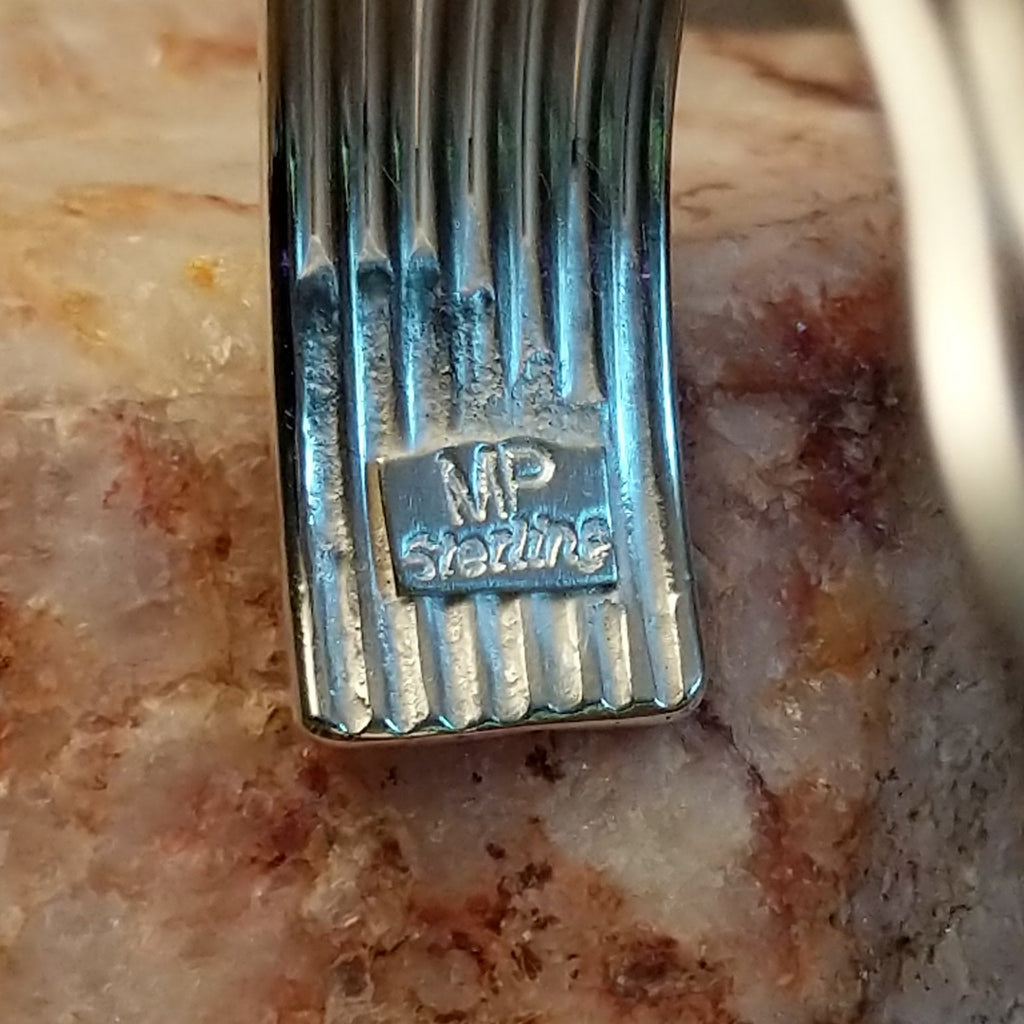 The artisan's stamped initials.