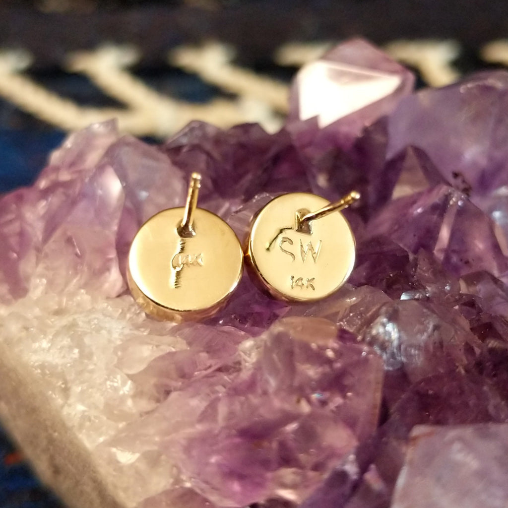 The artist's signature and gold stamp are found on the back of the earrings.