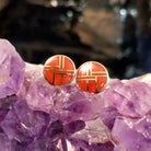 Round earrings with bright coral inlay and gold settings.