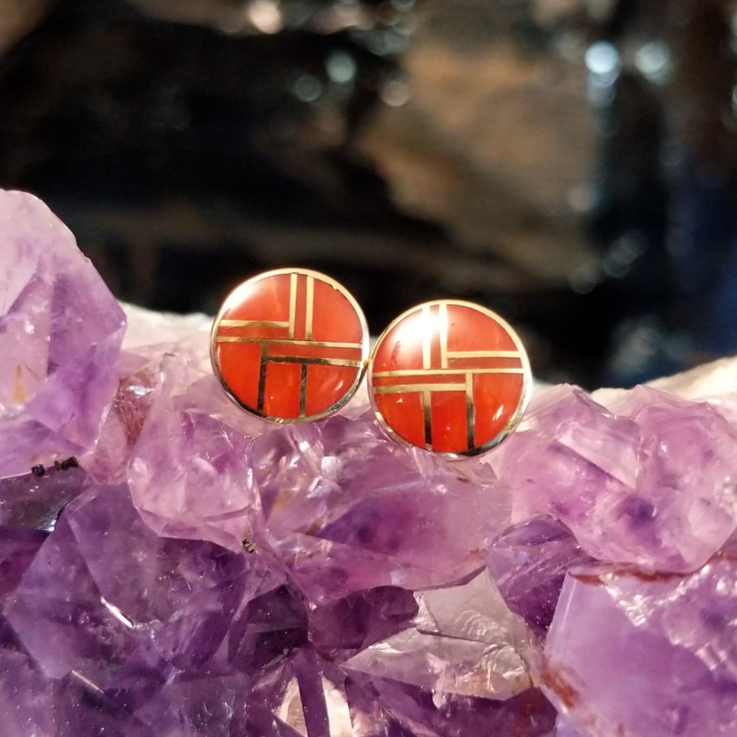 Round earrings with bright coral inlay and gold settings.