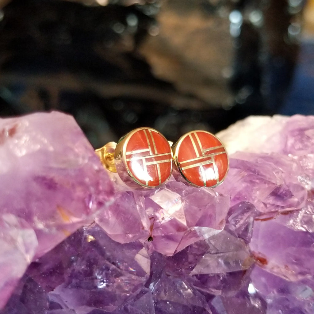 Round earrings with bright coral inlay and gold settings.