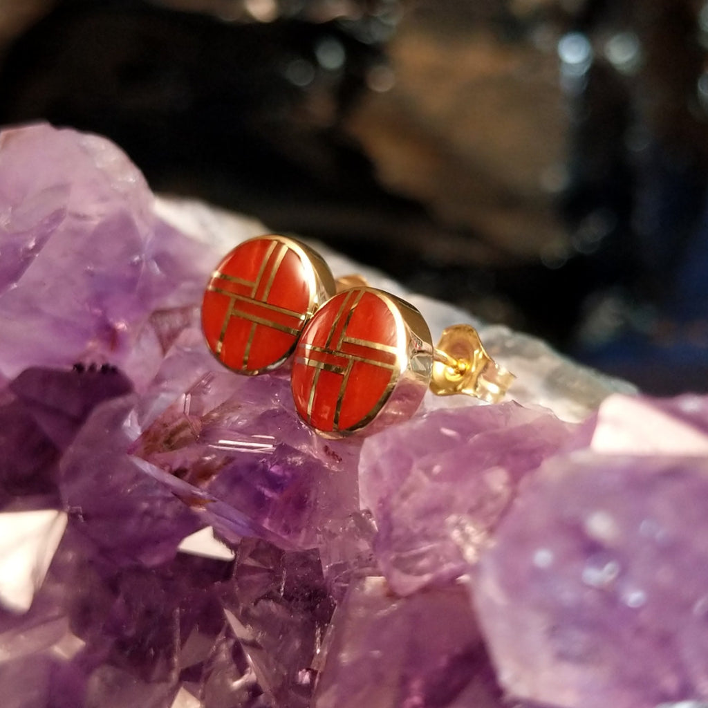 Round earrings with bright coral inlay and gold settings.