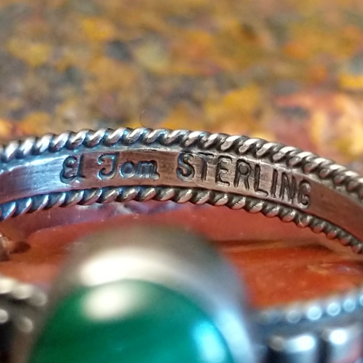 Close-up of the artisan's stamped signature.