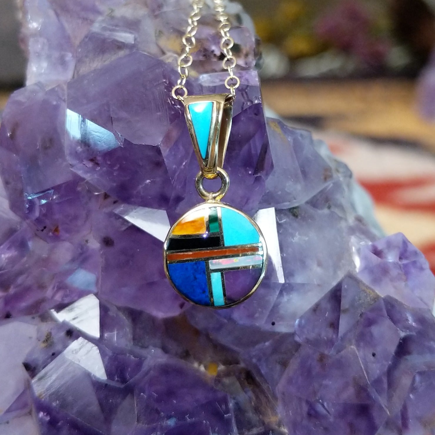 14kt gold round multistone inlay pendant by Selena Warner with geometric mosaic design and tapered gold bail.