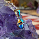 14kt gold round multistone inlay pendant by Selena Warner with geometric mosaic design and tapered gold bail.