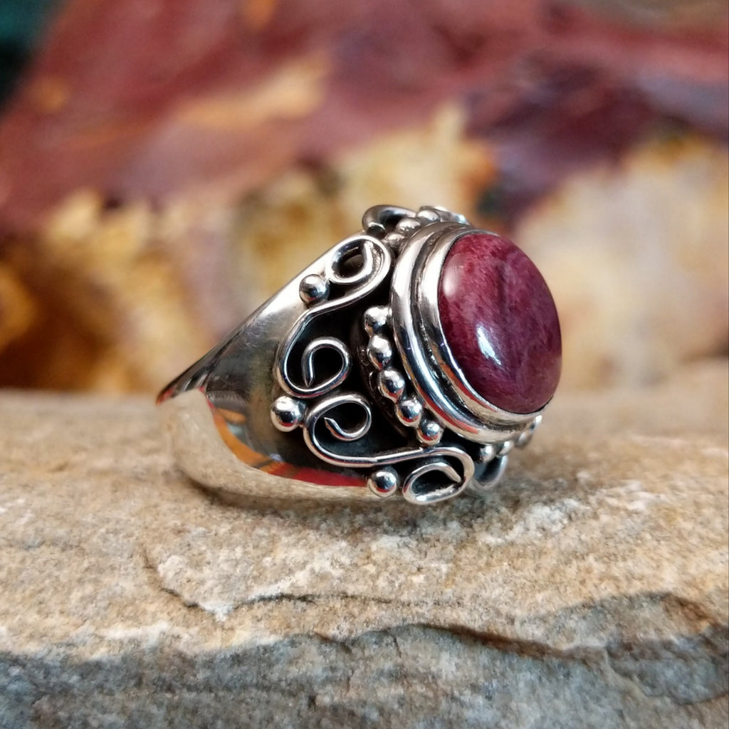 Purple spiny oyster shell in the scrolled silver setting of the ring.