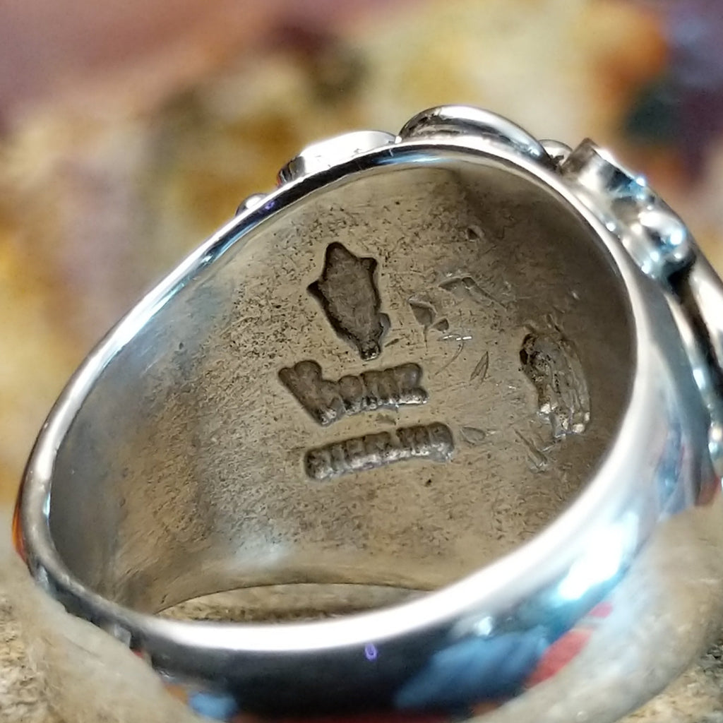 The artisan's signature is stamped on the inside of the band.