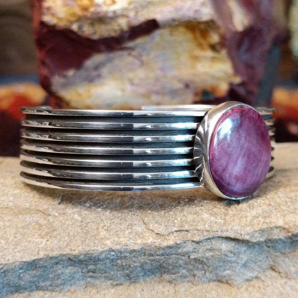 A round purple spiny oyster shell cuff in sterling silver with layered bands.