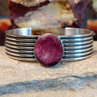 A round purple spiny oyster shell cuff in sterling silver with layered bands.