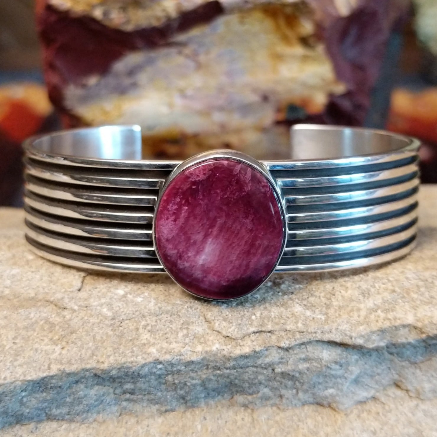 A round purple spiny oyster shell cuff in sterling silver with layered bands.