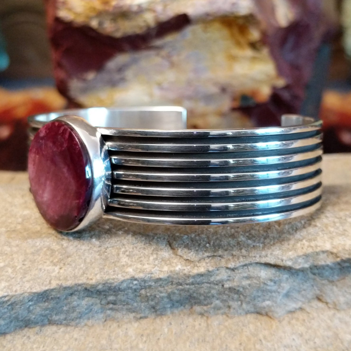 A round purple spiny oyster shell cuff in sterling silver with layered bands.