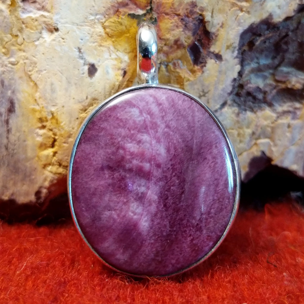 Round purple spiny oyster shell pendant set in sterling silver.