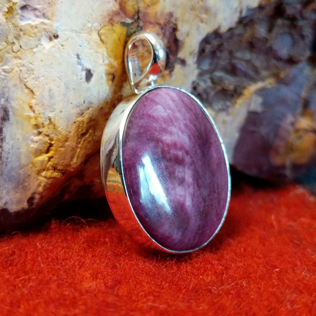 Round purple spiny oyster shell pendant set in sterling silver.