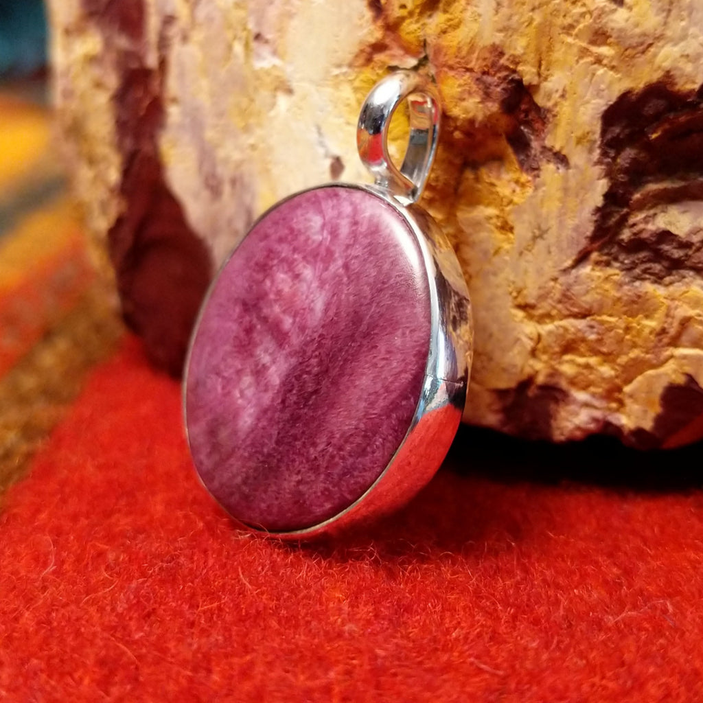 Round purple spiny oyster shell pendant set in sterling silver.