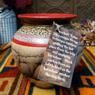 Round horsehair pottery vase by Roger Calhoun with a wide red rim, gold and lavender crackled shoulder, red accent band, and smoky black horsehair markings across a cream-colored body.