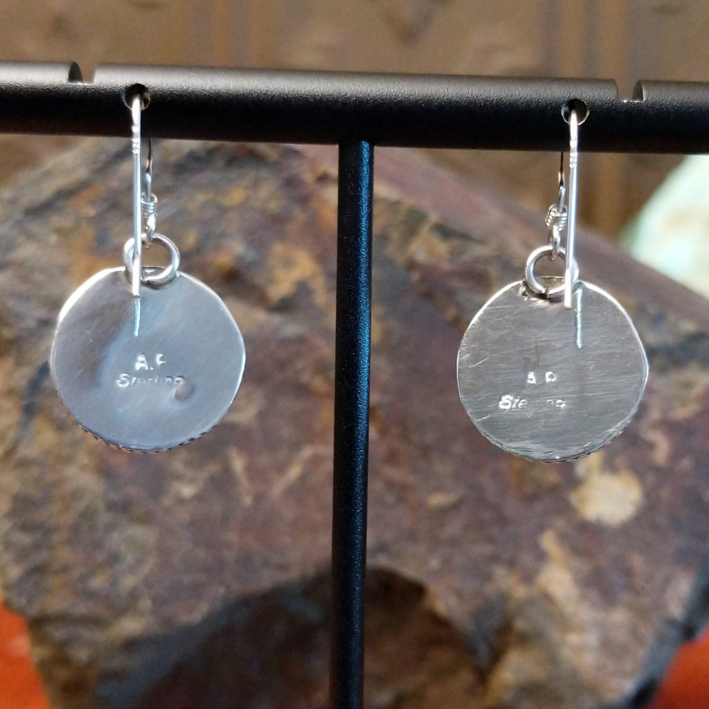 The backs are stamped with the artisan's signature.