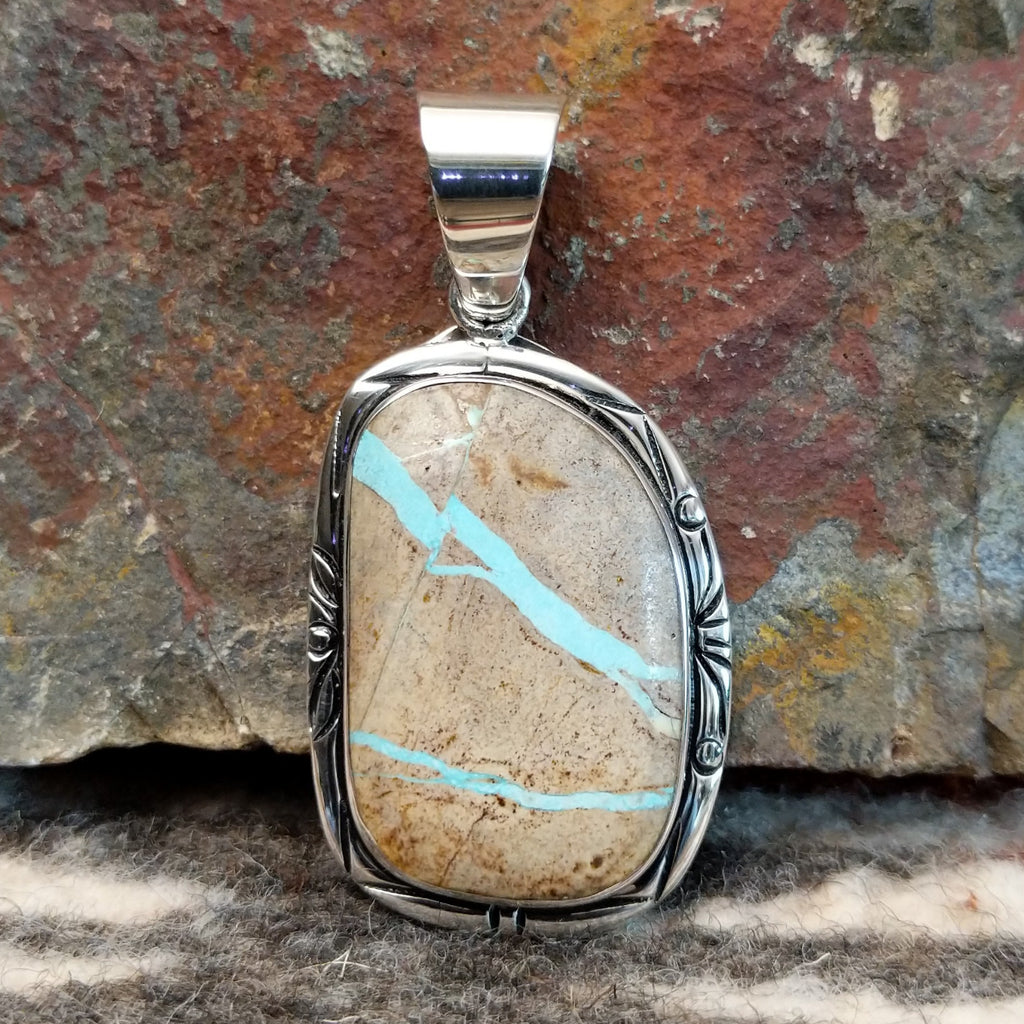 Sterling silver pendant with fine detailing and boulder turquoise set in the bezel.