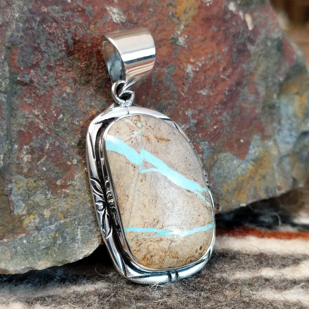 Sterling silver pendant with fine detailing and boulder turquoise set in the bezel.