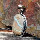Sterling silver pendant with fine detailing and boulder turquoise set in the bezel.