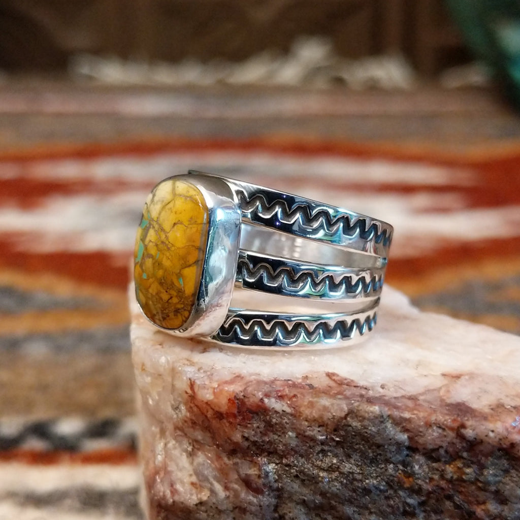Rectangular boulder turquoise set within the bezel of the ring.