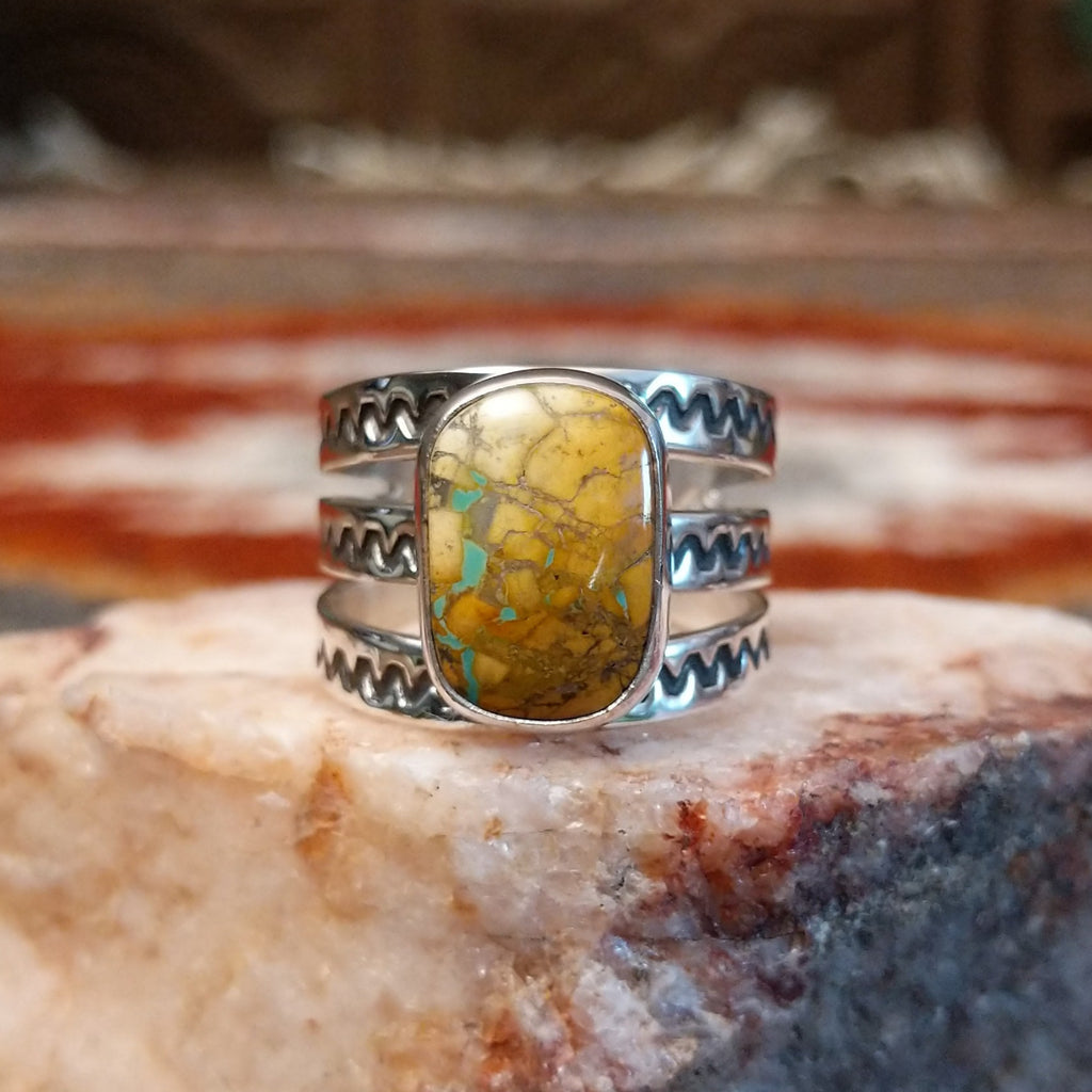 Rectangular boulder turquoise set within the bezel of the ring.