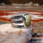 Rectangular boulder turquoise set within the bezel of the ring.