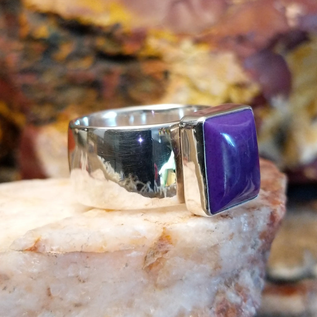 Sterling silver ring with square sugilite set in a raised bezel.