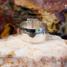 Sterling silver ring with square sugilite set in a raised bezel.