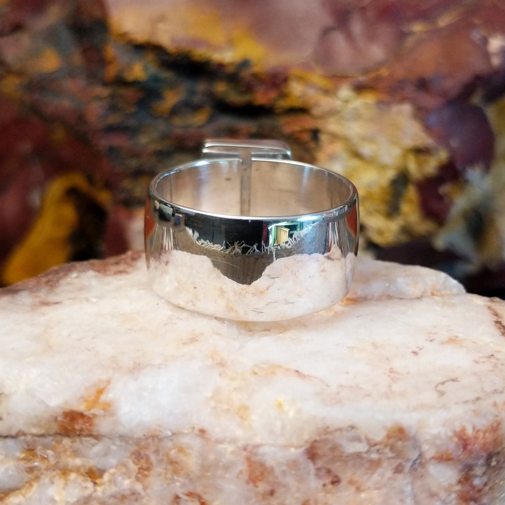 Sterling silver ring with square sugilite set in a raised bezel.