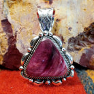 Triangular purple spiny oyster shell set in sterling silver with twisted rope accents, scalloped edges, and detailed dot work.