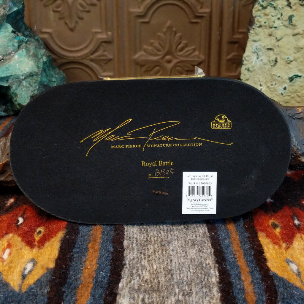 The artist's signature is on the bottom of the base.