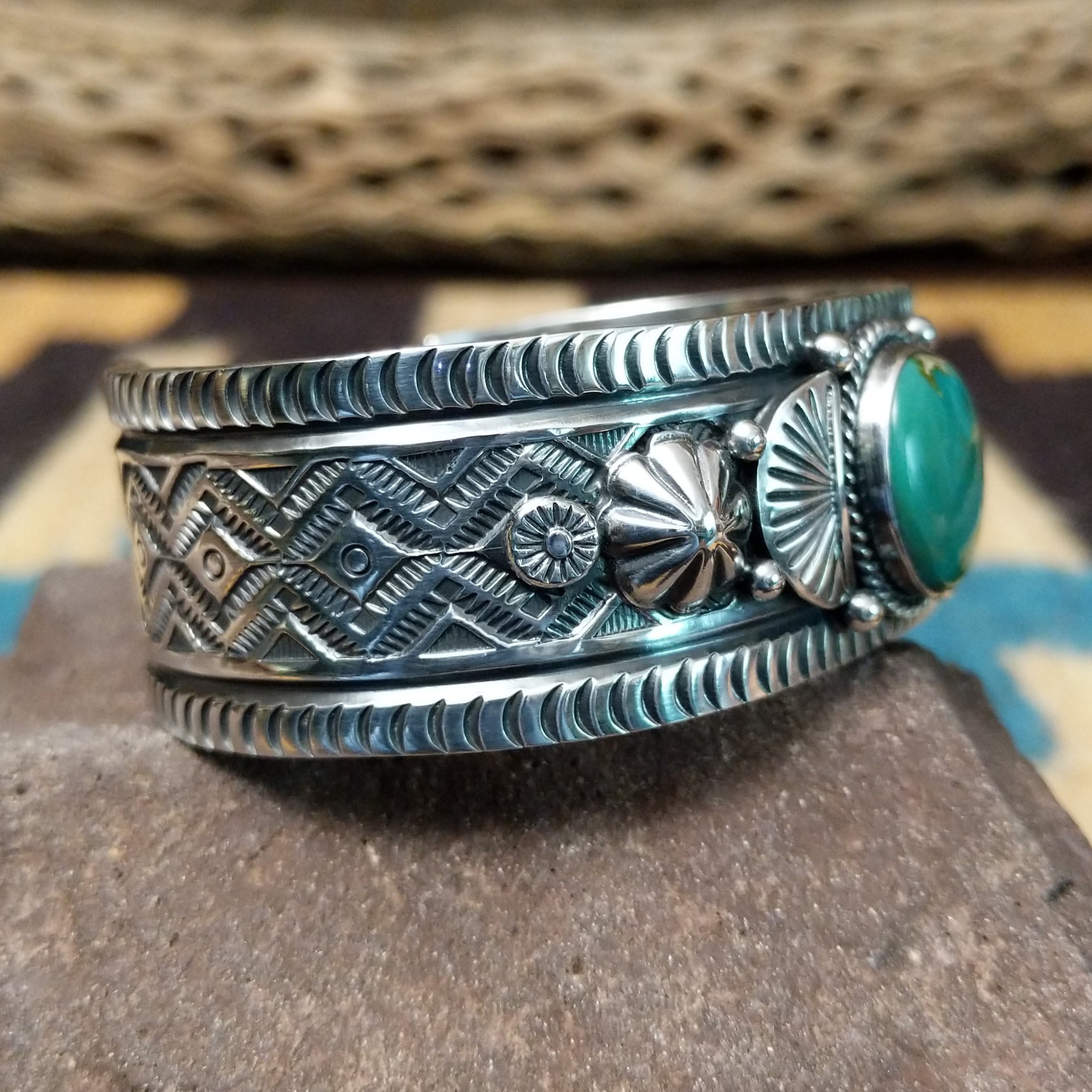 Royston turquoise cuff by Murphy Platero, featuring a vibrant blue and green Royston turquoise stone with natural matrix set in a handcrafted sterling silver open cuff.  Side view.